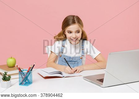 Smiling Little Kid Schoolgirl 12-13 Years Old Sit Studying At White Desk With Pc Laptop Isolated On 