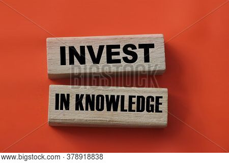 Investing In Knowledge Words On Wooden Blocks. Education Concept