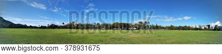 Panoramic Of Kapiolani Park At Dusk With Diamond Head And Clouds In The Distance On Oahu, Hawaii.