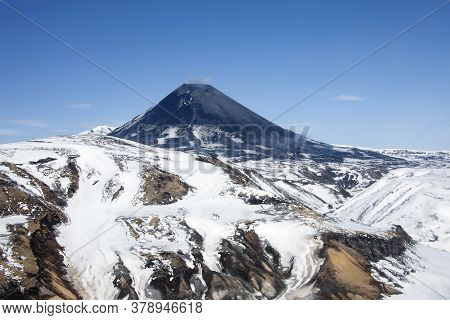 View Of The Correct Cone Of The Karymsky Volcano In The Spring After A Snowfall. Geothermal Activity