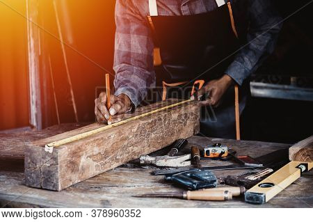 Carpenter Working On Woodworking Machines In Carpentry Shop.