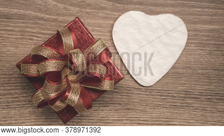 Red Gift Box With Golden Ribbon And White Heart Paper Cut For Surprise Valentines Day Present On Bro
