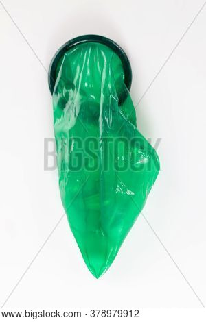 High-quality Green Latex Condom, A Means To Prevent Pregnancy And Infection, Close-up And Small Dept