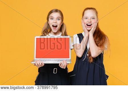 Two Girls 12-13 Years Old White T-shirt Blue School Uniform Hold Laptop Pc Computer Isolated On Yell