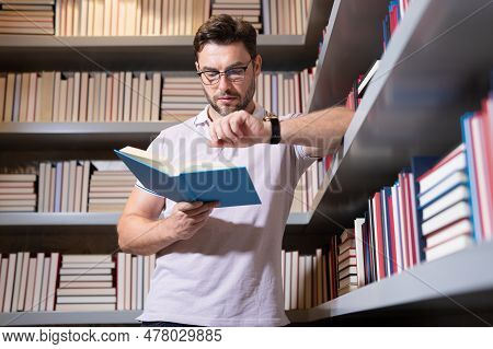 Portrait Of Professor With Book In Classroom. Handsome Professor In Library. Teachers Day. Good Prof