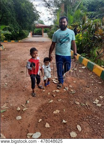 Indian Father With Daughter And Toddler Boy Kid Walking And Sitting In A Machohalli Forest Gate.