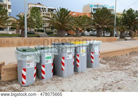 Alghero, Italy - May 29, 2023: Public Beach Waste Sorting In Municipal Garbage Bins In Alghero Town,
