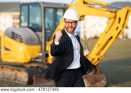 Construction Manager In Suit And Helmet At A Construction Site. Construction Manager Worker Or Super