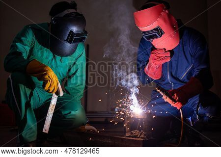 Metal Welding Steel Works Using Electric Arc Welding Machine To Weld Steel At Factory. Metalwork Man