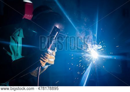 Metal Welding Steel Works Using Electric Arc Welding Machine To Weld Steel At Factory. Metalwork Man