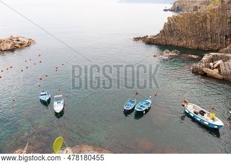 Picturesque Traditional Style Mediterranean Fishing Dinghies Moored In Bay Formed In Rocky Terrain O