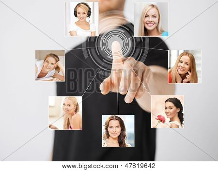 technology and communication - man pressing button on virtual screen with contact icons