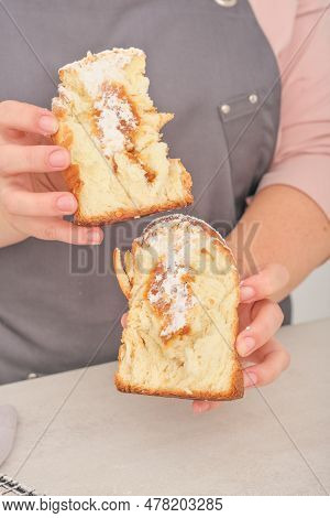 Female Hands Holding Craffing Cake With Caramel Filling Cut In Halves. Hand Made Pastry, Vertical