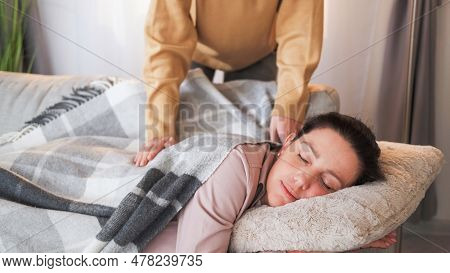 Home Nap. Caring Daughter. Loving Unrecognizable Girl Covering Plaid Mother Sleeping On Sofa Weekend