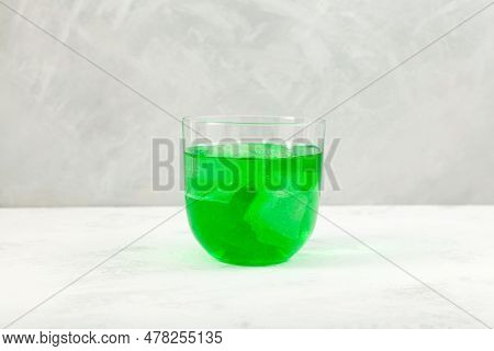 Khus Sharbat Or Green Vetiver Drink. Glass Of Chrysopogon Zizanioides Extract With Ice Cubes. Popula