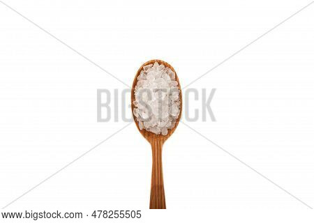 Large Lemon Salt Crystals In Wooden Spoon Isolated On White Background, Close-up. Citric Acid Salt. 