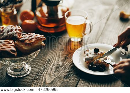 Close Up Image Of A Woman Eating Cherry Pastries With Fork And Knif In Cafe