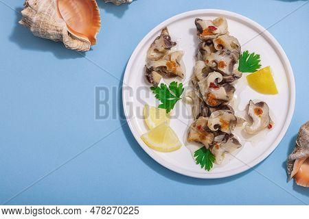 Pickled Rapan Meat With Oil, Spices And Greens. Healthy Seafood Rich Of Omega