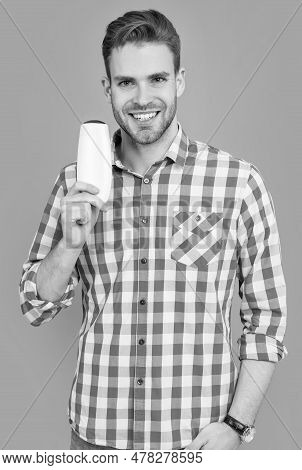 Unbranded Cosmetic For Cheerful Man. Stylish Man Hold Bottle Of Unbranded Cosmetic.