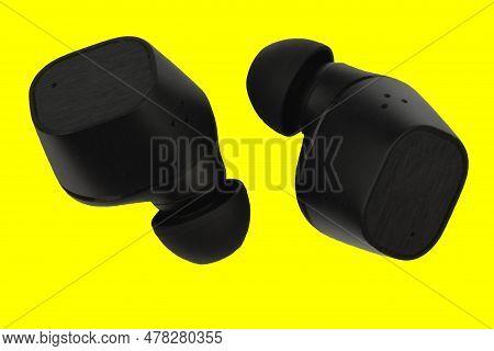 Wireless Stereo Earbuds. Black Wireless Earphones. Earbuds Or Headphones Isolated On Yellow Backgrou