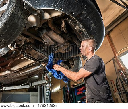 Repairman, Worker Repairing Car, Holding Rag, Wiping. Strong, Hardworking Man Working In Servicing C