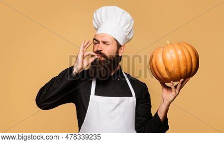 Male Chef With Pumpkin Showing Sign Ok. Bearded Man In Chef Uniform With Pumpkin. Organic Food. Heal