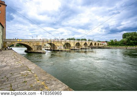 Regensburg, Bavaria - De - June 5, 2023 Horizontal View Of The 12th-century Stone Bridge, Crossing T