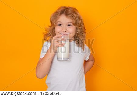 Milk. Child With Glass Of Milk On Studio Yellow Background. Kid With Milk Moustache. Fun Portrait Of