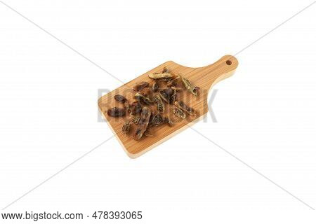 Dried Fruits Of Sophora Japonica On Wooden Board On White Background. Fruits And Seeds Are Used In A
