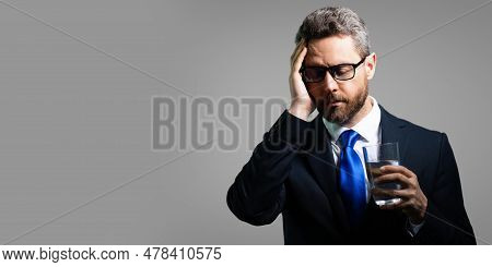 Millennial Businessman Having Headache. Business Man In Suit Suffer From Migraine Or Headache. Tired
