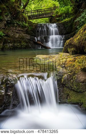 The Sychryd Cascades Or Sgydau Sychryd Falls With Wooden Bridge In The Waterfall Country Near The Di