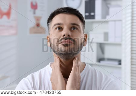Endocrine System. Man Doing Thyroid Self Examination Indoors