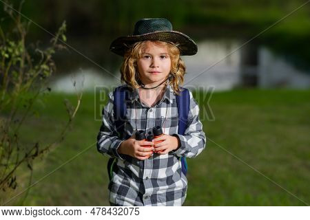 Scout Boy Wearing Explorer Hat And Backpack Outdoor. Explorer And Adventure With Binocular.