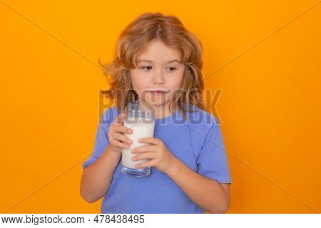 Kid Drink Fresh Milk. Studio Isolated Portrait Of Child Drinking Milk. Kid With Glass Of Milk And Mi