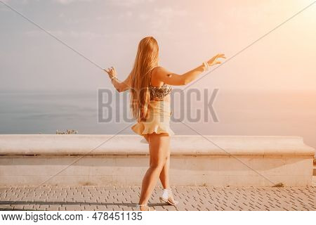 Woman Summer Dance. Silhouette Of A Happy Woman Who Dances, Spins And Raises Her Hands To The Sky. A