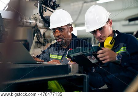 Factory Workers Working With Adept Robotic Arm In A Workshop . Industry Robot Programming Software F
