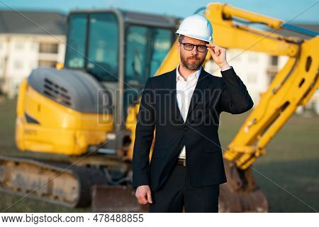Construction Business Owner. Man In Suit And Hardhat Halmet At Building Construction Site. Civil Eng