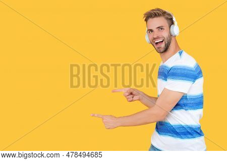 Estudy Man In Headphones Pointing Finger On Yellow Background Banner With Copy Space