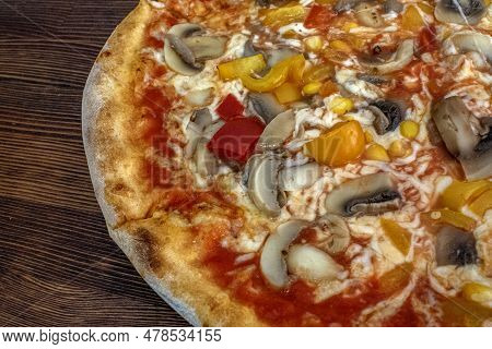Funghi Pizza With Tomato Sauce, Cheese, Mushrooms, Peppers And Corn On Wooden Table