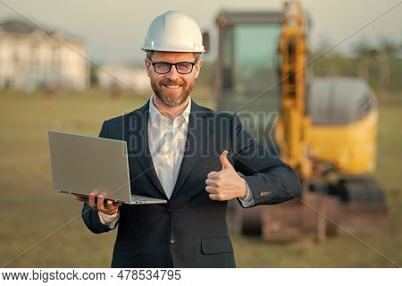 Construction Business Owner. Man In Suit And Hardhat Halmet At Building Construction Site. Civil Eng