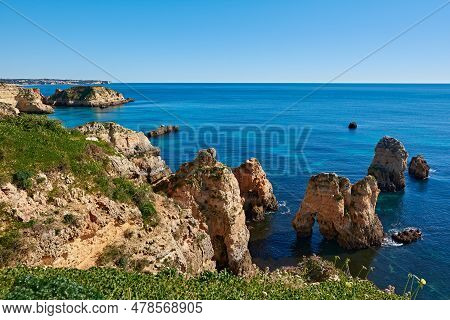 Typical Algarvian Landscape With Lots Of Limestone Rocks In The Water And A Deep Blue Ocean. Portuga