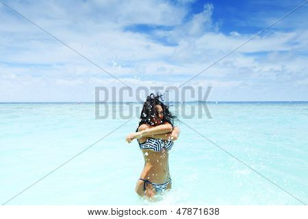 Vrolijke vrij jonge vrouw splashin in zee