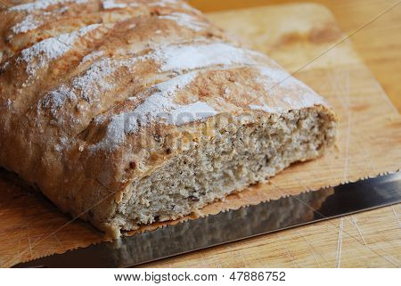 Sourdough On Chopping Board With Knife