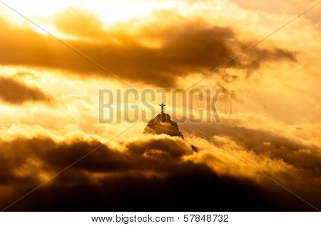 Christ the Redeemer Statue in Clouds on Sunset