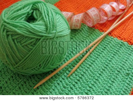 Green clew and needle for knitting