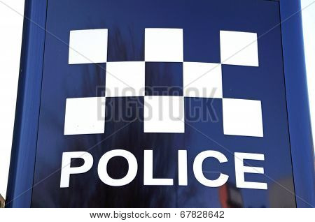 Police sign with chequered design.