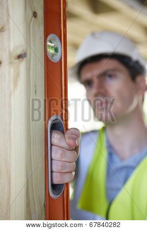 Builder Checking Work With Spirit Level