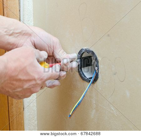 Certified Electrician Installing Socket For Light Switch.