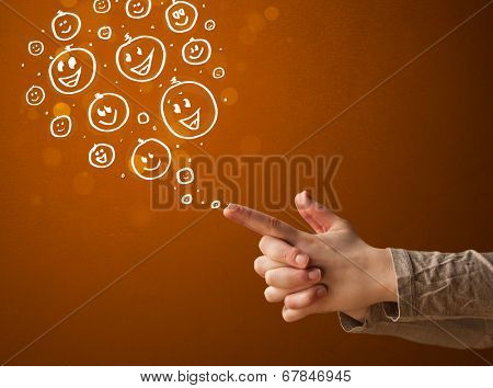 Group of happy hand drawed smiley faces coming out of gun shaped hands