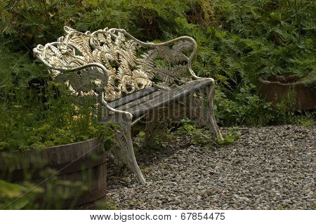 White wrought iron garden bench